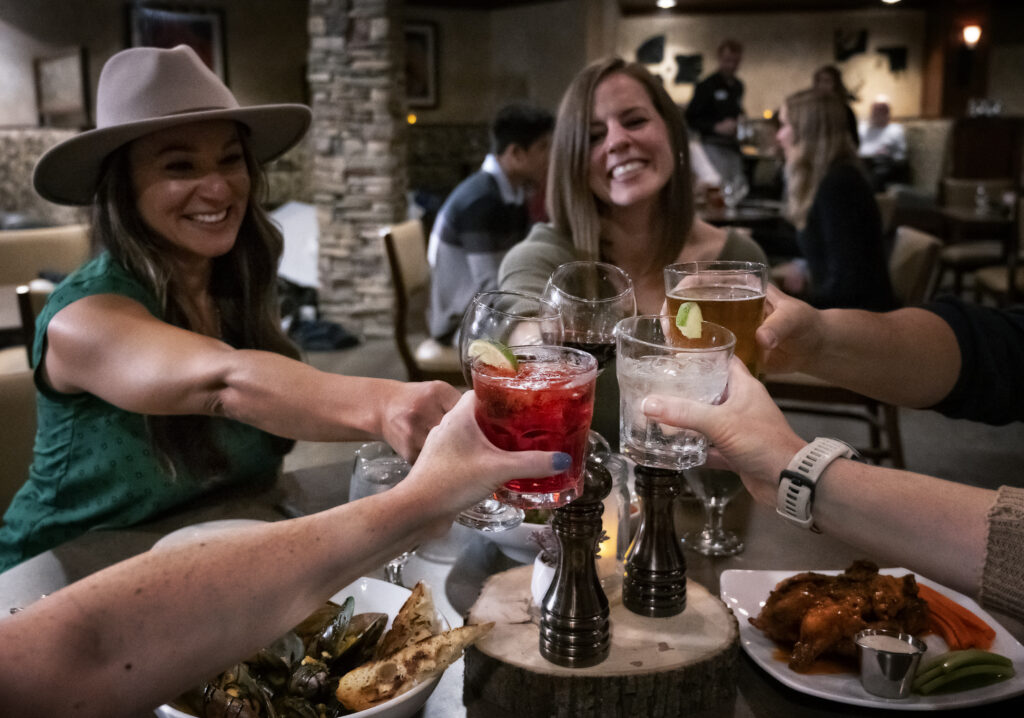 people toasting at dinner in Spencer's