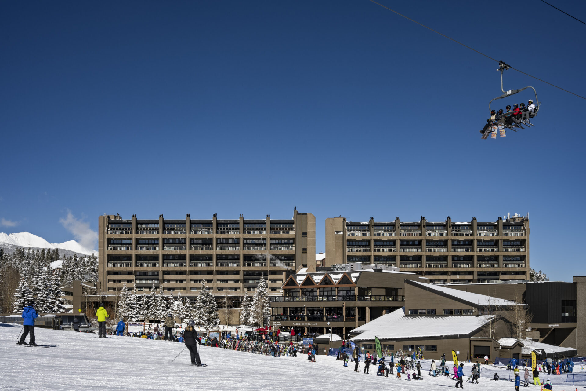 Skiers skiing and riding the Beaver Run SuperChair by Beaver Run