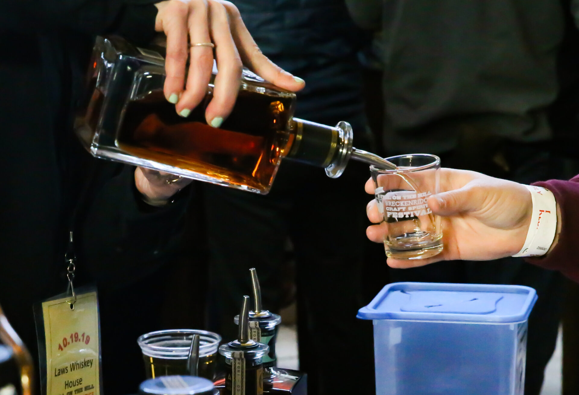Close up pour of liquor into Still on the Hill festival event cup